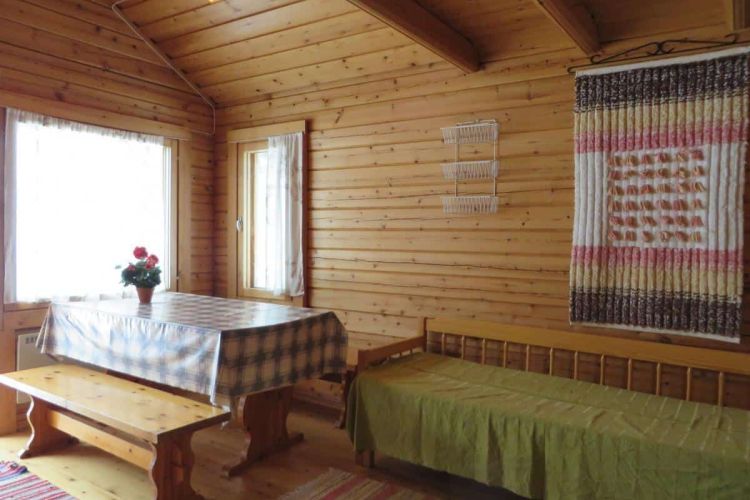 Pirttiruokapöytä ja levitettävä vuodesohva.